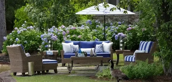 A serene outdoor seating area surrounded by blooming hydrangeas