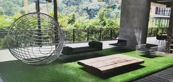 Modern outdoor lounge featuring a wire spherical chair