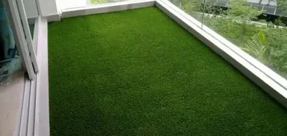 balcony featuring lush green artificial grass flooring